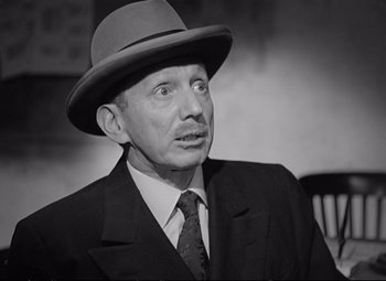 Movie still from “The Asphalt Jungle” (1950), directed by John Huston – An older man wearing a suit and a hat; Close Up shot, Low angle
