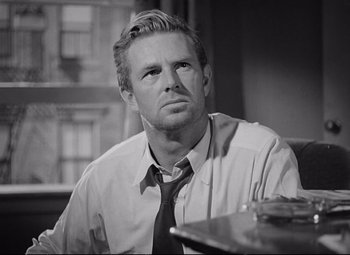 Movie still from “The Asphalt Jungle” (1950), directed by John Huston – Black and white photograph of a man in a dress shirt and tie; Close Up shot, Low angle