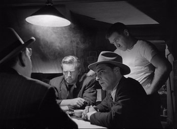 Movie still from “The Asphalt Jungle” (1950), directed by John Huston – A black and white photo of men sitting at a table; Medium shot, Over the shoulder angle