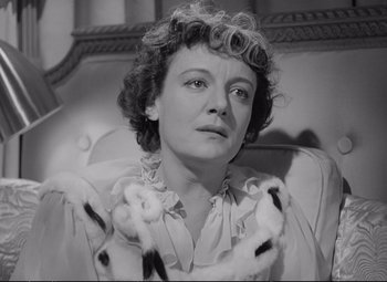 Movie still from “The Asphalt Jungle” (1950), directed by John Huston – An old black and white photo of a woman; Close Up shot, High angle