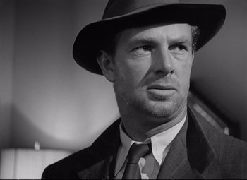 Movie still from “The Asphalt Jungle” (1950), directed by John Huston – Black and white photograph of a man wearing a hat; Close Up shot, Low angle