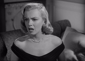 Movie still from “The Asphalt Jungle” (1950), directed by John Huston – An old photo of a woman in a black dress; Close Up shot, Over the shoulder angle