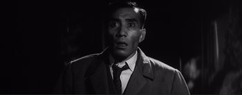Movie still from “The Bad Sleep Well” (1960), directed by Akira Kurosawa – A man in a suit and tie looking surprised; Close Up shot, Low angle