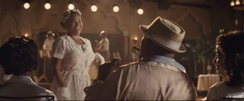 Movie still from “The Banker” (2020), directed by George Nolfi – A man and a woman are dancing in a room; Medium shot, Over the shoulder angle