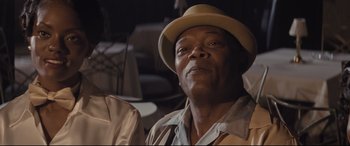 Movie still from “The Banker” (2020), directed by George Nolfi – An older man wearing a hat and a jacket; Close Up shot, Low angle