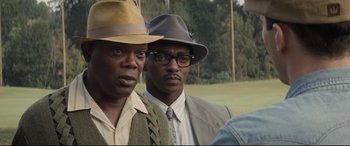 Movie still from “The Banker” (2020), directed by George Nolfi – A couple of men standing next to each other; Close Up shot, Over the shoulder angle