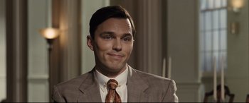 Movie still from “The Banker” (2020), directed by George Nolfi – A person wearing a suit and tie; Close Up shot, Over the shoulder angle