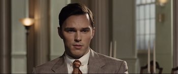 Movie still from “The Banker” (2020), directed by George Nolfi – A man in a suit and tie looking to his left; Close Up shot, Over the shoulder angle