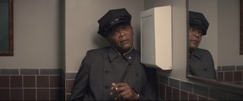 Movie still from “The Banker” (2020), directed by George Nolfi – A man wearing a hat and a jacket; Close Up shot, Low angle