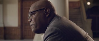 Movie still from “The Banker” (2020), directed by George Nolfi – An older man wearing glasses and a suit; Close Up shot, Low angle