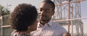 Movie still from “The Banker” (2020), directed by George Nolfi – A man and a woman smiling at each other; Close Up shot, Over the shoulder angle