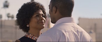 Movie still from “The Banker” (2020), directed by George Nolfi – A man and a woman standing next to each other; Close Up shot, Over the shoulder angle