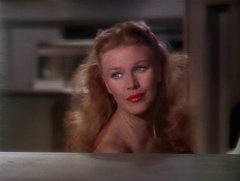 Movie still from “The Barkleys of Broadway” (1949), directed by Charles Walters – A woman with long blonde hair and red lipstick; Close Up shot, Over the shoulder angle