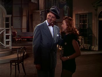 Movie still from “The Barkleys of Broadway” (1949), directed by Charles Walters – A man and a woman standing next to each other; Medium shot, Over the shoulder angle