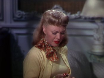 Movie still from “The Barkleys of Broadway” (1949), directed by Charles Walters – A woman in a yellow sweater and a red neck tie; Close Up shot, Over the shoulder angle
