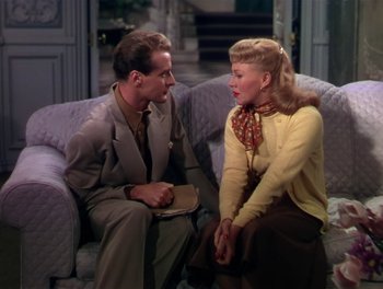 Movie still from “The Barkleys of Broadway” (1949), directed by Charles Walters – A man and a woman sitting on a couch talking to each other; Medium shot, High angle