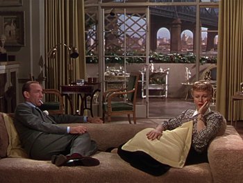 Movie still from “The Barkleys of Broadway” (1949), directed by Charles Walters – A man and a woman sitting on a couch in a living room; Wide shot, High angle