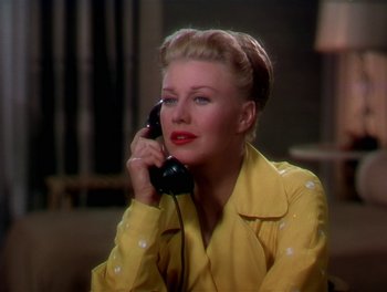 Movie still from “The Barkleys of Broadway” (1949), directed by Charles Walters – A woman talking on a phone while wearing a yellow jacket; Close Up shot, Low angle