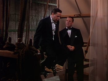 Movie still from “The Barkleys of Broadway” (1949), directed by Charles Walters – Two men in tuxedos standing next to each other; Medium shot, Low angle