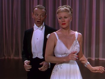 Movie still from “The Barkleys of Broadway” (1949), directed by Charles Walters – A man and a woman standing next to each other in front of a curtain; Medium shot, Low angle