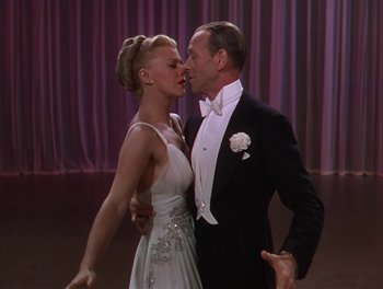 Movie still from “The Barkleys of Broadway” (1949), directed by Charles Walters – A man and a woman in formal wear kissing; Medium shot, High angle