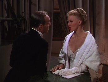 Movie still from “The Barkleys of Broadway” (1949), directed by Charles Walters – A man and a woman sitting at a dinner table; Medium shot, Over the shoulder angle