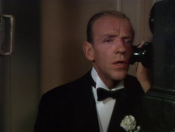 Movie still from “The Barkleys of Broadway” (1949), directed by Charles Walters – A person wearing a suit and tie; Close Up shot, Over the shoulder angle