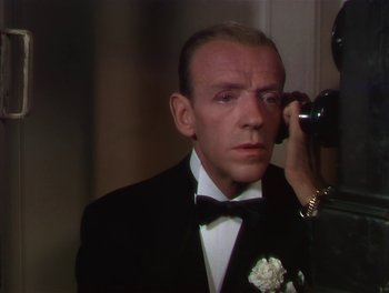 Movie still from “The Barkleys of Broadway” (1949), directed by Charles Walters – A man in a tuxedo talking on a phone; Close Up shot, Over the shoulder angle