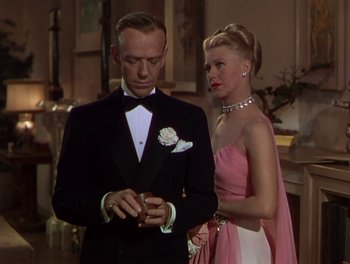Movie still from “The Barkleys of Broadway” (1949), directed by Charles Walters – A man and a woman standing next to each other in formal wear; Medium shot, Over the shoulder angle