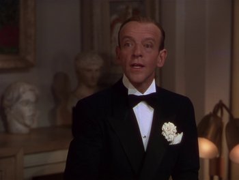 Movie still from “The Barkleys of Broadway” (1949), directed by Charles Walters – A man in a tuxedo standing in front of a statue; Close Up shot, Over the shoulder angle