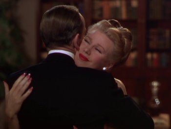Movie still from “The Barkleys of Broadway” (1949), directed by Charles Walters – A man and a woman hugging each other in formal wear; Close Up shot, Over the shoulder angle
