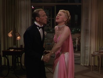 Movie still from “The Barkleys of Broadway” (1949), directed by Charles Walters – A man and a woman in formal wear holding hands; Medium shot, High angle