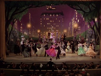 Movie still from “The Barkleys of Broadway” (1949), directed by Charles Walters – A large group of people are dancing on a stage; Extreme Wide shot, High angle