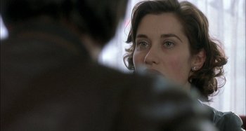 Movie still from “The Beat That My Heart Skipped” (2005), directed by Jacques Audiard – A person looking into a mirror; Close Up shot, Over the shoulder angle