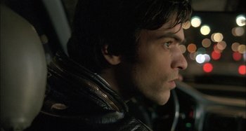 Movie still from “The Beat That My Heart Skipped” (2005), directed by Jacques Audiard – A person wearing a leather jacket; Close Up shot, High angle