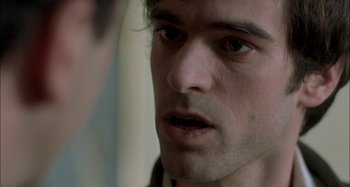 Movie still from “The Beat That My Heart Skipped” (2005), directed by Jacques Audiard – A man's face looking at the camera; Close Up shot, Over the shoulder angle
