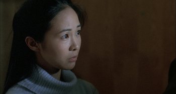 Movie still from “The Beat That My Heart Skipped” (2005), directed by Jacques Audiard – A person wearing a sweater; Close Up shot, Over the shoulder angle