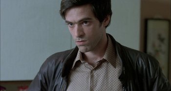Movie still from “The Beat That My Heart Skipped” (2005), directed by Jacques Audiard – A person wearing a shirt and jacket; Close Up shot, High angle