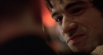 Movie still from “The Beat That My Heart Skipped” (2005), directed by Jacques Audiard – A man's face with a blurry background; Extreme Close Up shot, Over the shoulder angle