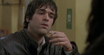 Movie still from “The Beat That My Heart Skipped” (2005), directed by Jacques Audiard – A person smoking a cigarette; Close Up shot, High angle