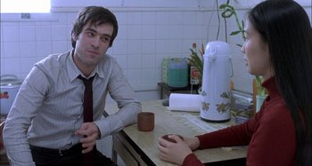 Movie still from “The Beat That My Heart Skipped” (2005), directed by Jacques Audiard – A man and a woman sitting at a kitchen table; Medium shot, Over the shoulder angle