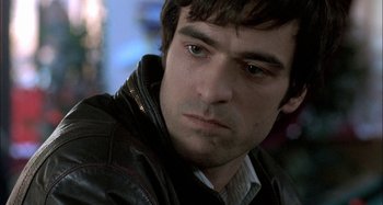 Movie still from “The Beat That My Heart Skipped” (2005), directed by Jacques Audiard – A person wearing a leather jacket; Close Up shot, Over the shoulder angle