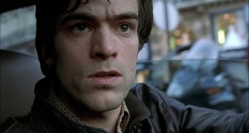 Movie still from “The Beat That My Heart Skipped” (2005), directed by Jacques Audiard – A person wearing a jacket; Close Up shot, High angle
