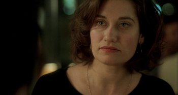 Movie still from “The Beat That My Heart Skipped” (2005), directed by Jacques Audiard – A person wearing a black shirt; Close Up shot, Over the shoulder angle