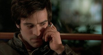 Movie still from “The Beat That My Heart Skipped” (2005), directed by Jacques Audiard – A person talking on a cell phone; Close Up shot, High angle