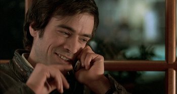 Movie still from “The Beat That My Heart Skipped” (2005), directed by Jacques Audiard – A person talking on a cell phone; Close Up shot, Over the shoulder angle