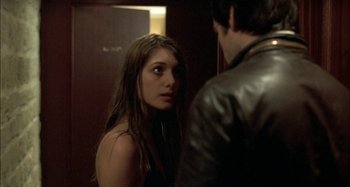 Movie still from “The Beat That My Heart Skipped” (2005), directed by Jacques Audiard – A woman looking at a man in front of a mirror; Close Up shot, Over the shoulder angle