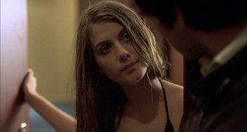 Movie still from “The Beat That My Heart Skipped” (2005), directed by Jacques Audiard – A woman with long brown hair looking at the camera; Close Up shot, Over the shoulder angle