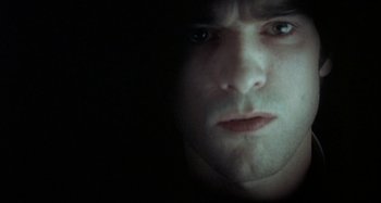 Movie still from “The Beat That My Heart Skipped” (2005), directed by Jacques Audiard – A man's face in the dark; Close Up shot, Overhead angle