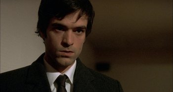 Movie still from “The Beat That My Heart Skipped” (2005), directed by Jacques Audiard – A person wearing a suit and tie; Close Up shot, High angle
